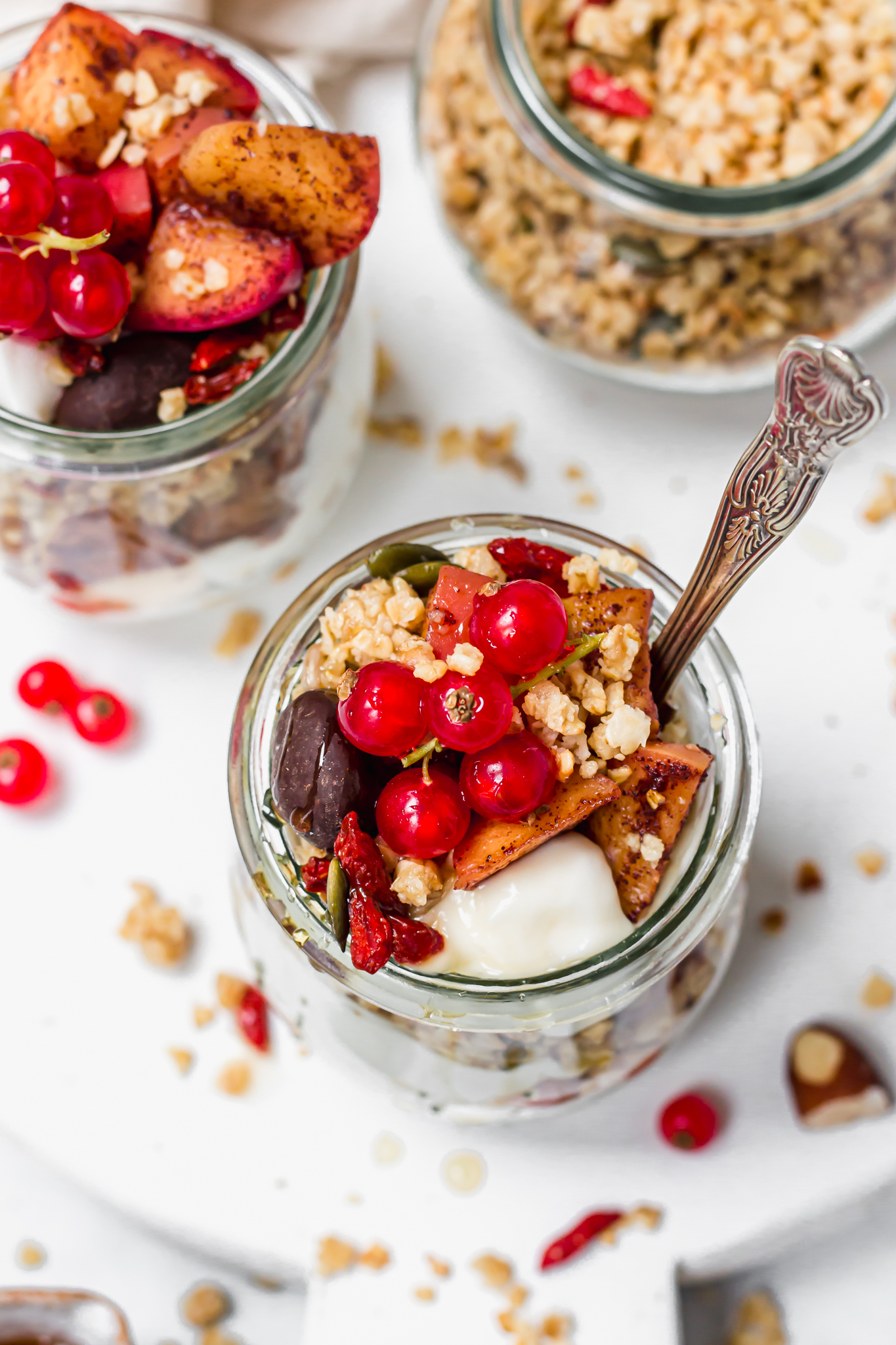 Apple Streusel Parfait Jars with red currants and a spoon