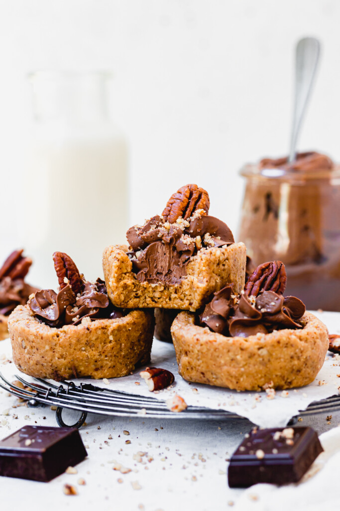 A stack of three Mini Chocolate Mousse Pecan Tarts