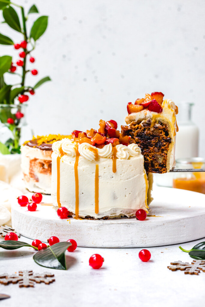 Lifting a slice out from a Easy Vegan Christmas Cake Caramel Apple