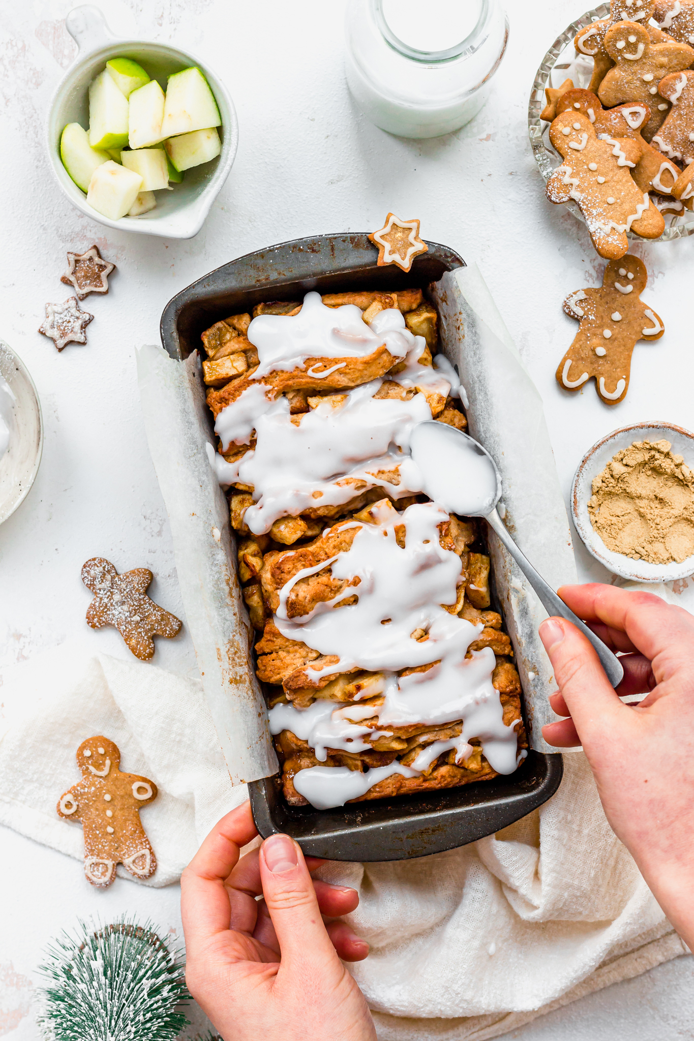 Spreading icing over Gingerbread Apple Pull Apart Bread
