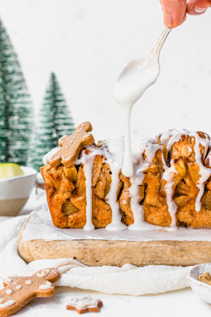 Pouring icing over Gingerbread Apple Pull Apart Bread