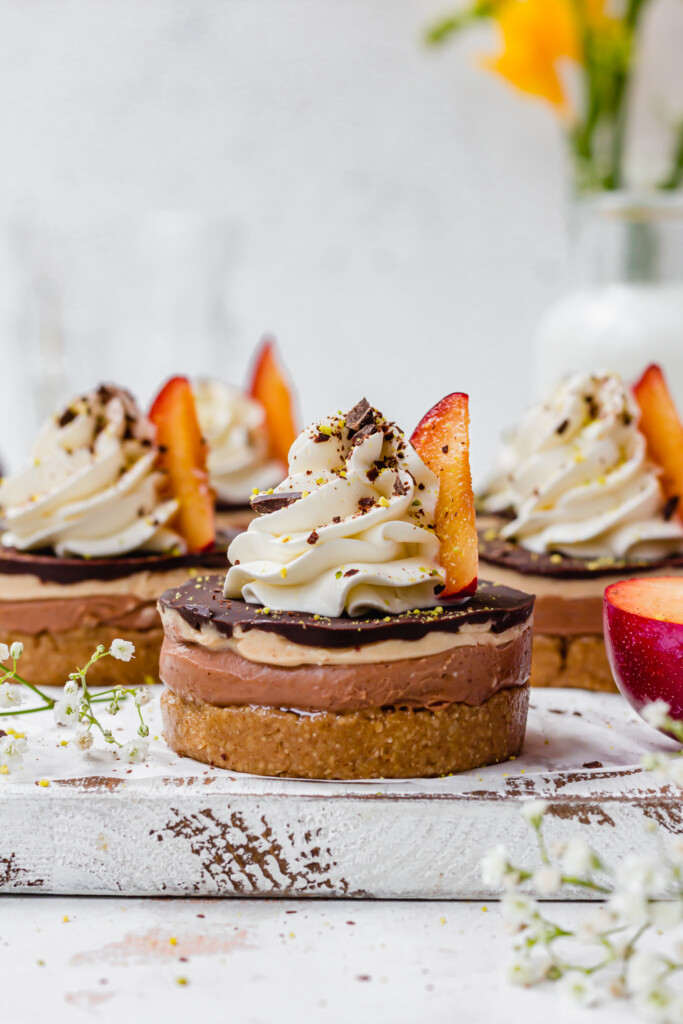 Chocolate Plum Mini Cheesecakes on a wooden board