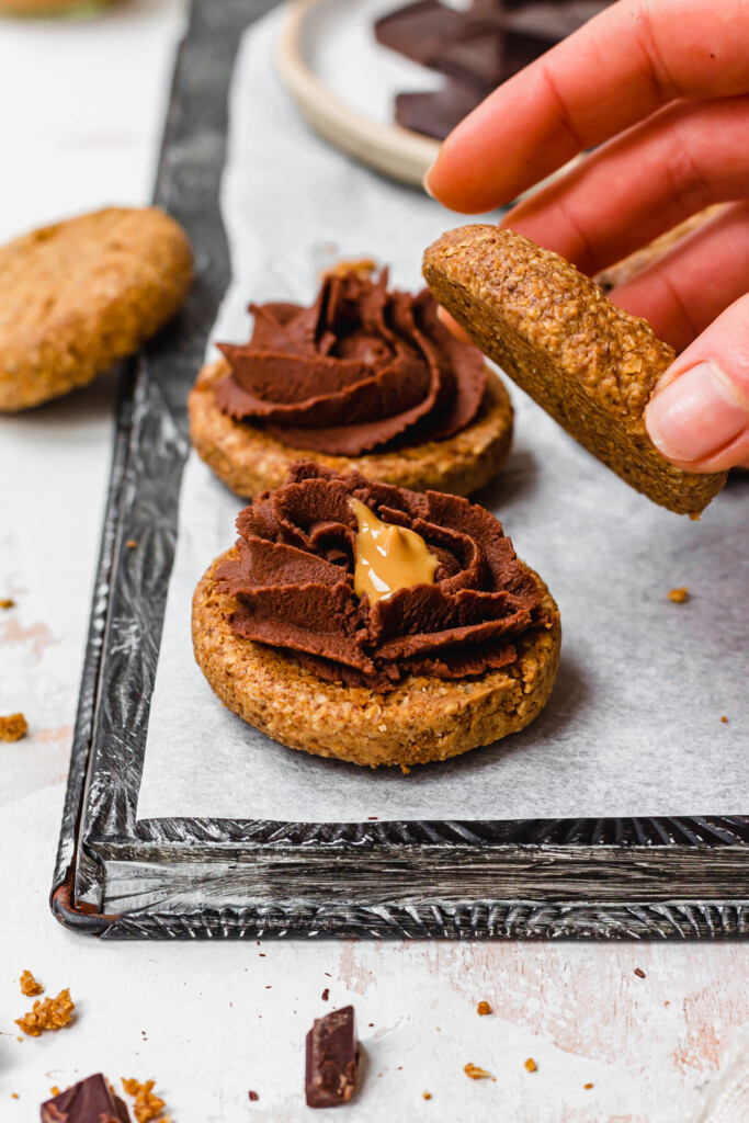 Sandwiching together Chocolate Filled Peanut Butter Cookie Sandwiches