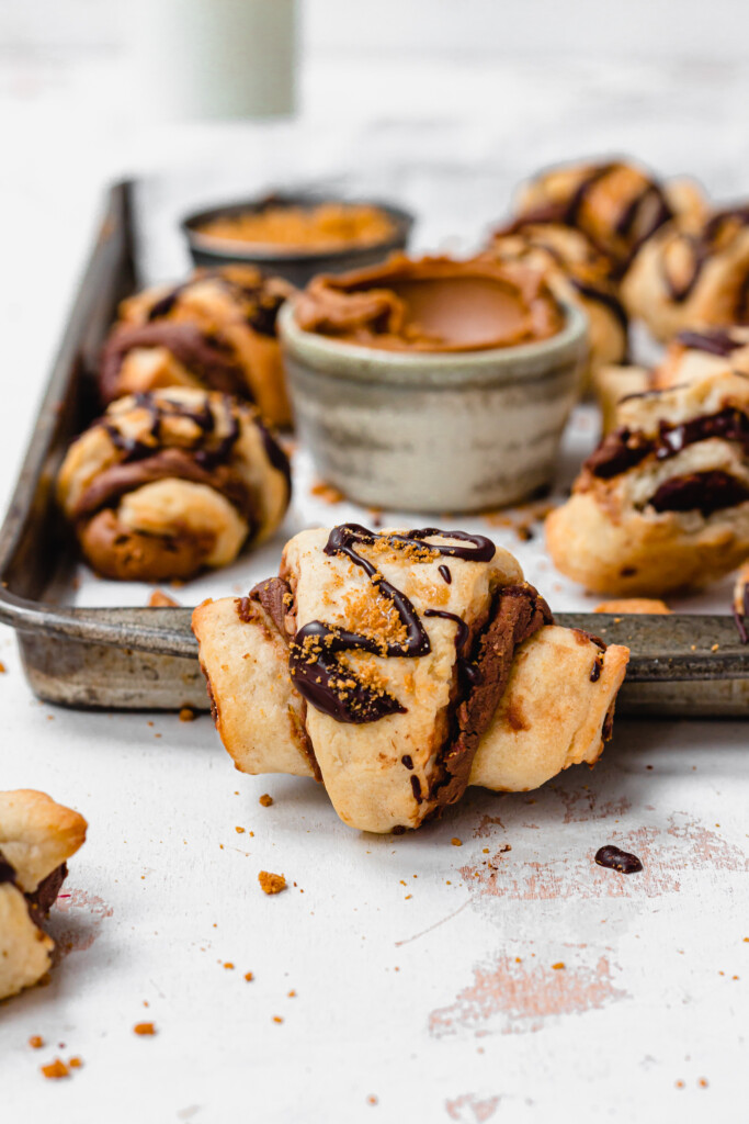 Mini Vegan Chocolate Biscoff Croissants leaning on a metal tray