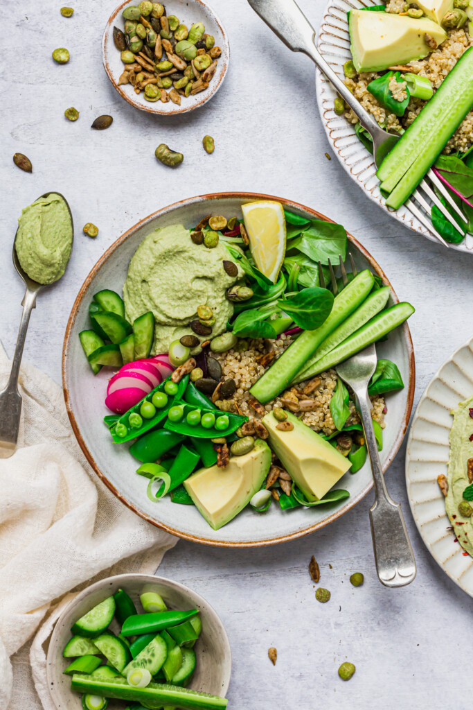 Two Minty Pea Hummus Quinoa Bowls with forks