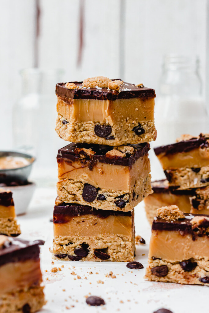 A stack of three Cashew Chocolate Chip Cookie Caramel Bars