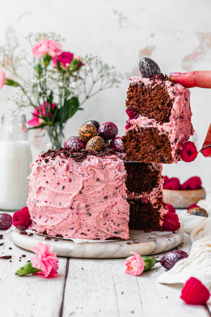 Lifting out a slice of Dark Chocolate Raspberry Speckle Cake