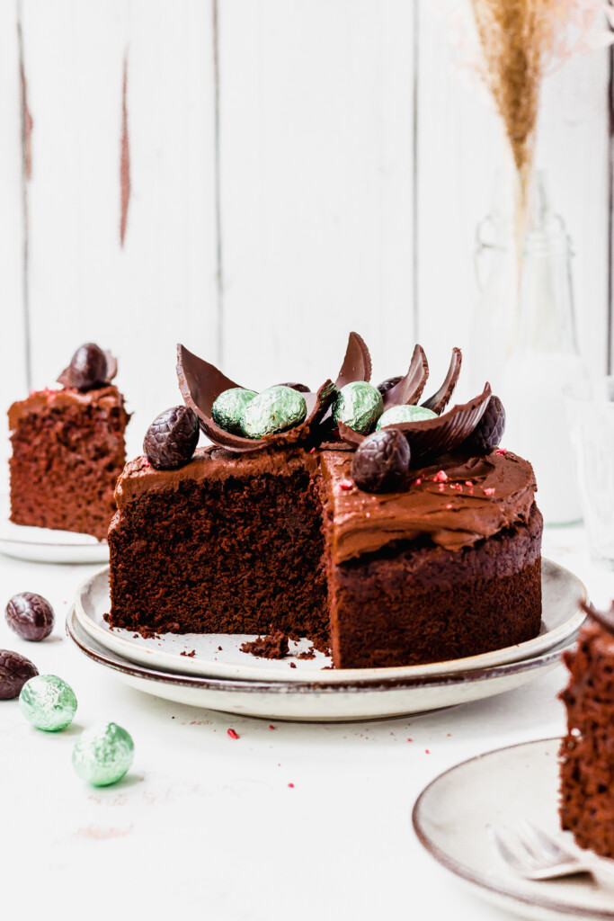 A Vegan Easter Egg Chocolate Cake with two slices of cake