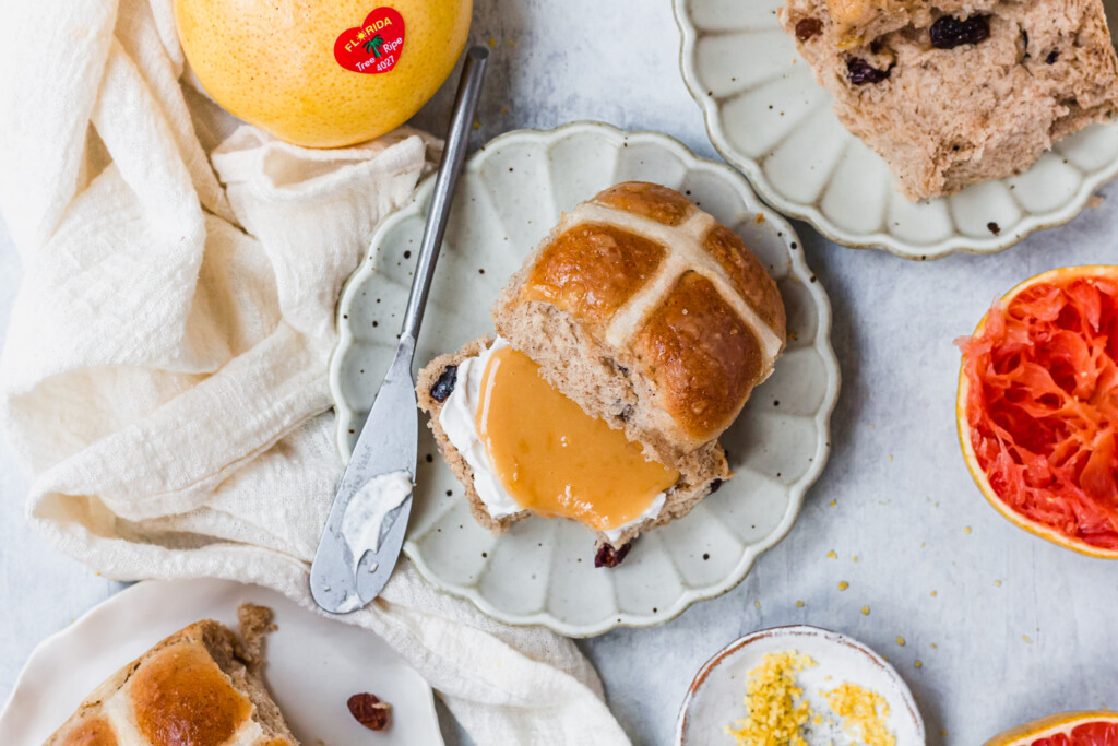Easy Vegan Hot Cross Buns cut open with cream and syrup
