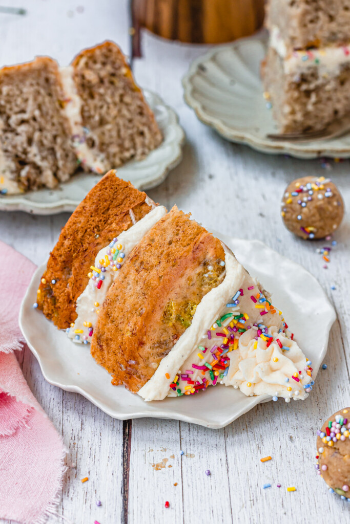 A slice of Funfetti Banana Bread with sprinkle buttercream
