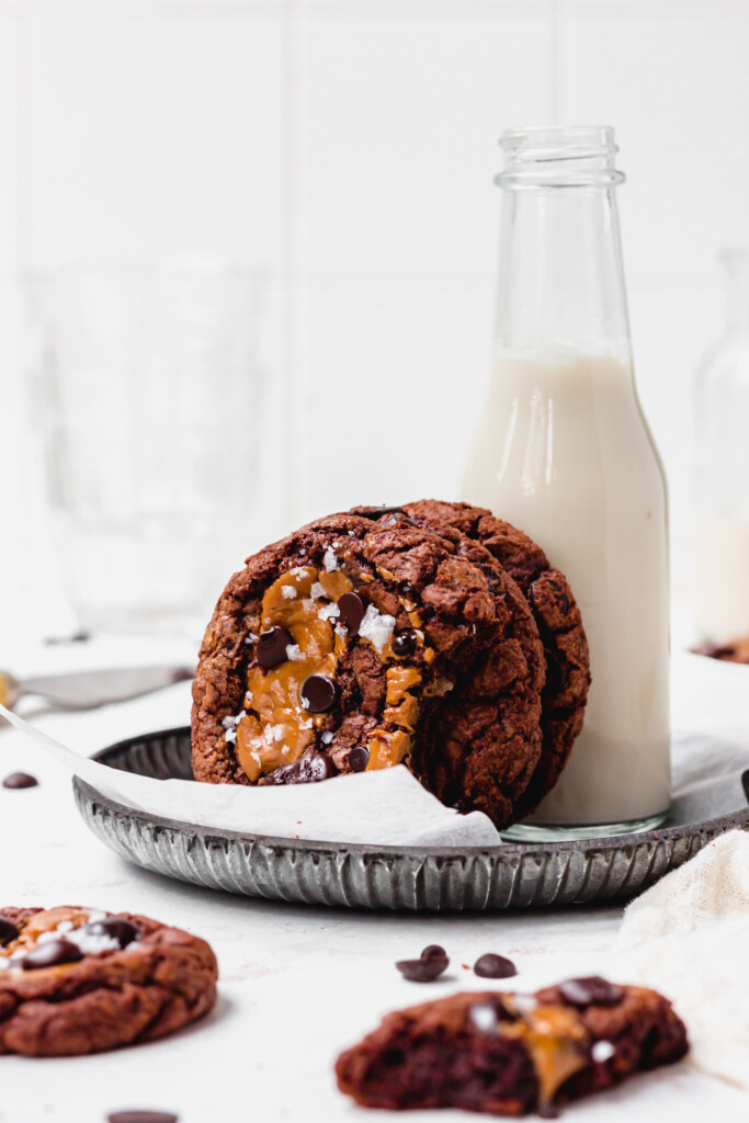 A bottle of milk and three Vegan Peanut Butter Chocolate Brownie Cookies