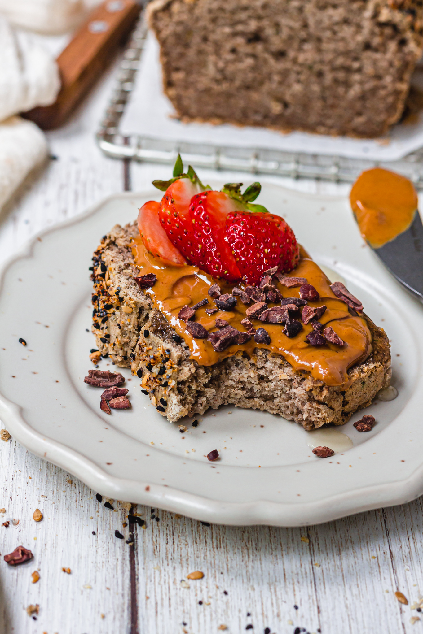 Peanut butter and strawberries on a slice of Gluten-Free Vegan Buckwheat Bread
