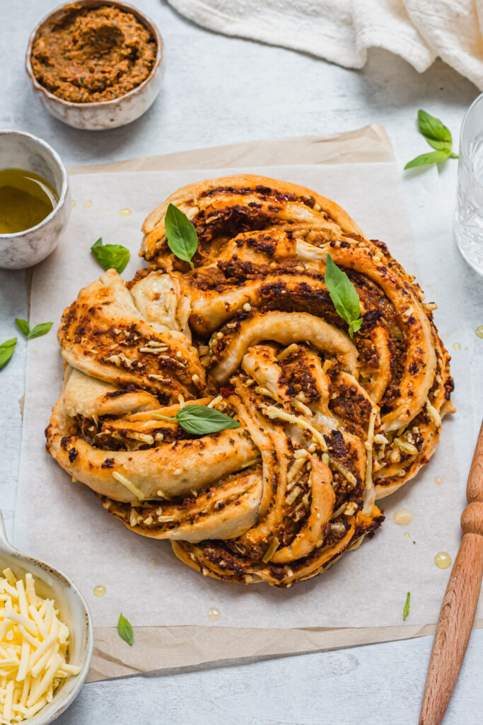 Sun-Dried Tomato Pesto Babka Wreath with a pastry brush and cheese