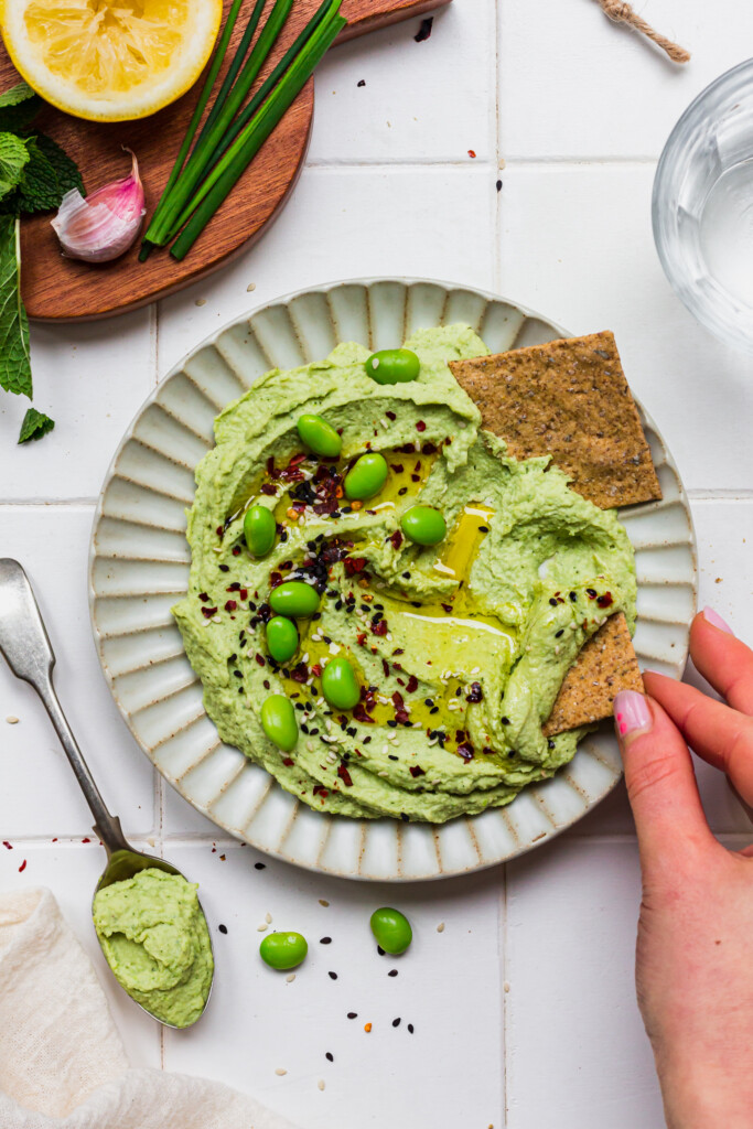 Edamame and Butterbean Hummus with a hand