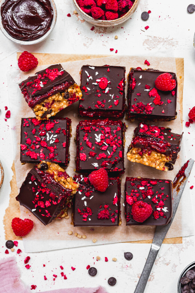 Nine Chocolate Raspberry Crunch Bars on parchment paper