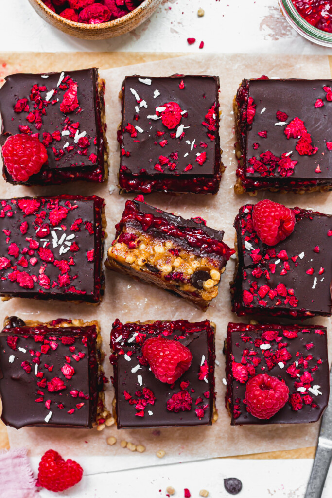 Nine Chocolate Raspberry Crunch Bars on parchment paper