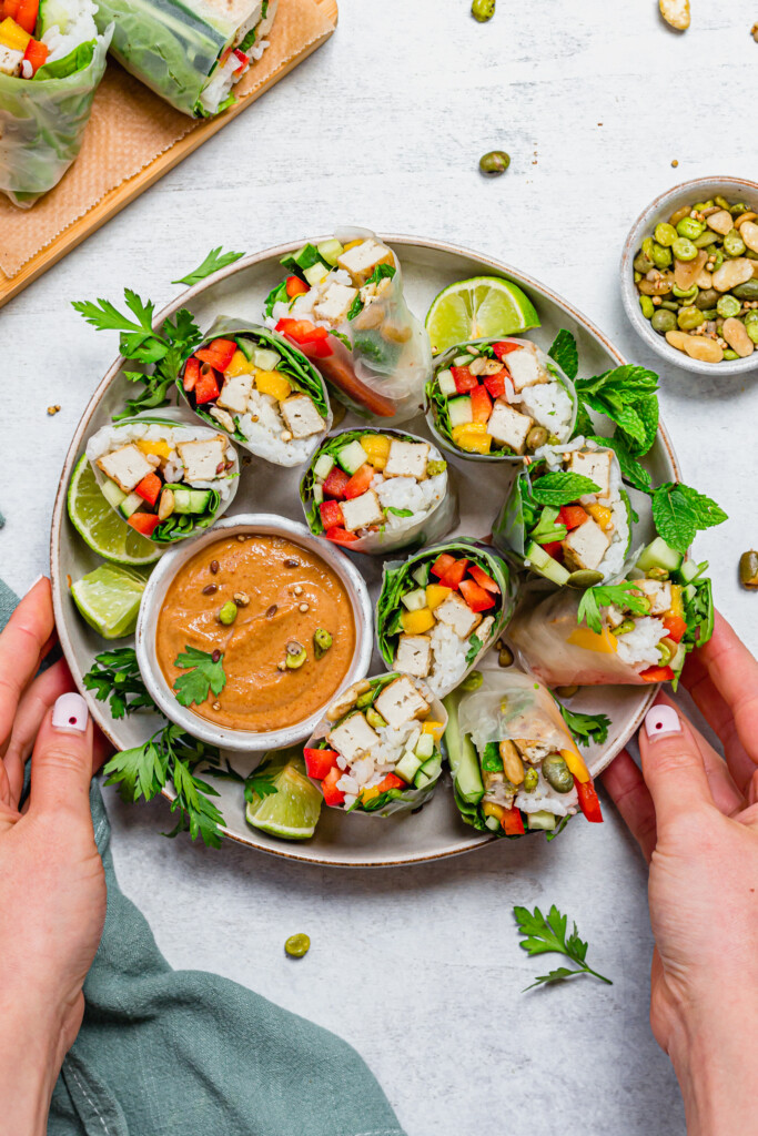 Salt and Pepper Tofu Summer Rolls with two hands
