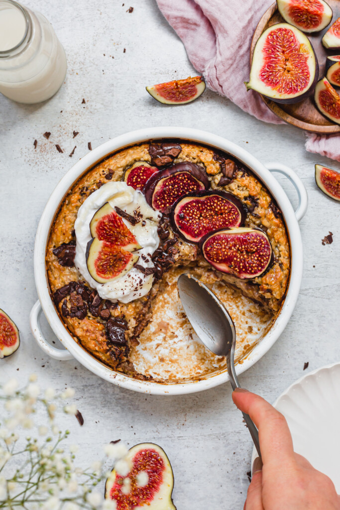 Chocolate and Fig Baked Oats with a piece missing and a spoon