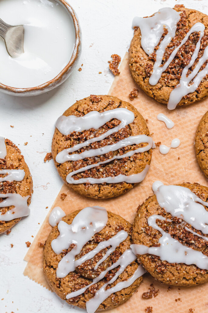 Cinnamon Streusel Cookies on parchment paper with icing glaze