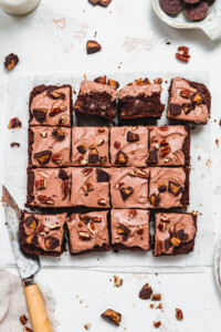 16 squares of Pecan Peanut Butter Cup Frosted Brownies