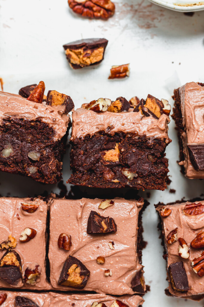 Two pieces of Pecan Peanut Butter Cup Frosted Brownies