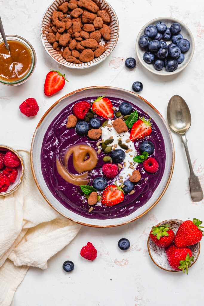 Blueberry Caramel Smoothie Bowl with a spoon on the side