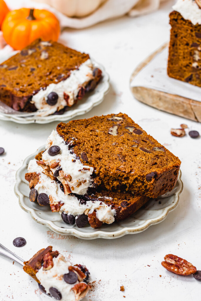 Two slices of Chocolate Chip Chai Pumpkin Loaf on a plate