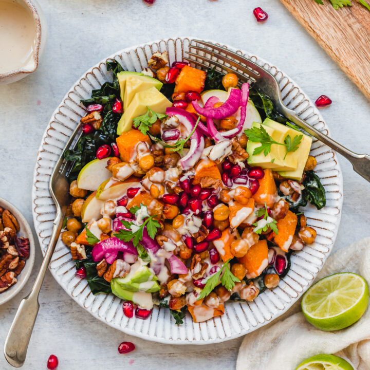 Two forks in a bowl of Ginger Roasted Squash and Chickpea Salad with Tahini