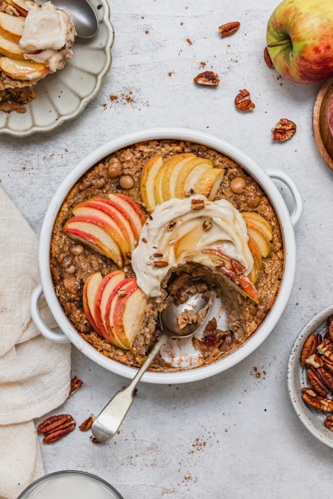Toffee Apple Pecan Baked Oats with a piece missing and a spoon