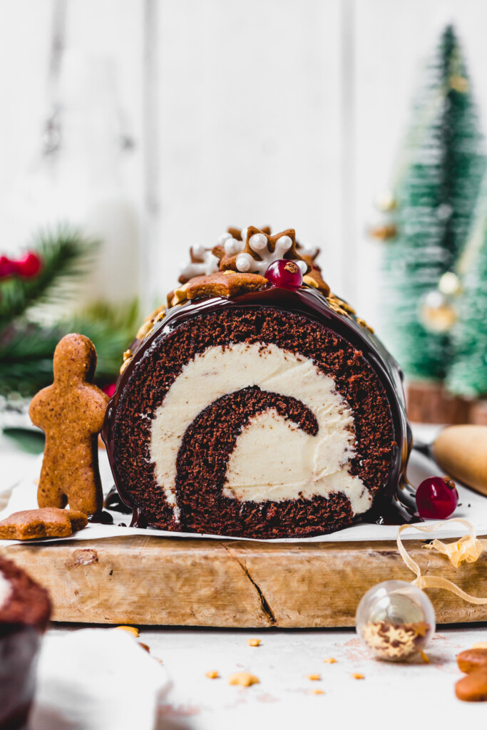 Close up of Best Vegan Chocolate Swiss Roll with a gingerbread cookie