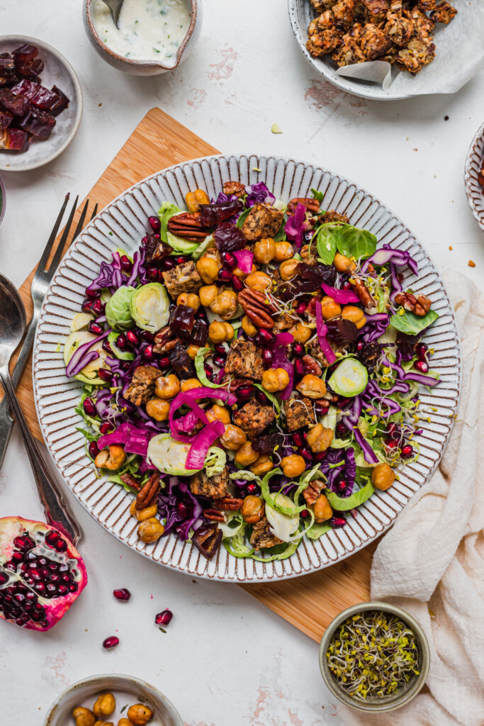 Brussel Sprout Red Cabbage Slaw with Crunchy Chickpeas in a white rimmed bowl