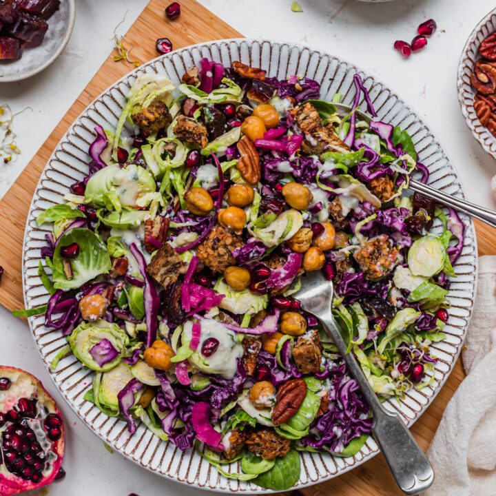 Tossed Brussel Sprout Red Cabbage Slaw with Crunchy Chickpeas with a fork and spoon