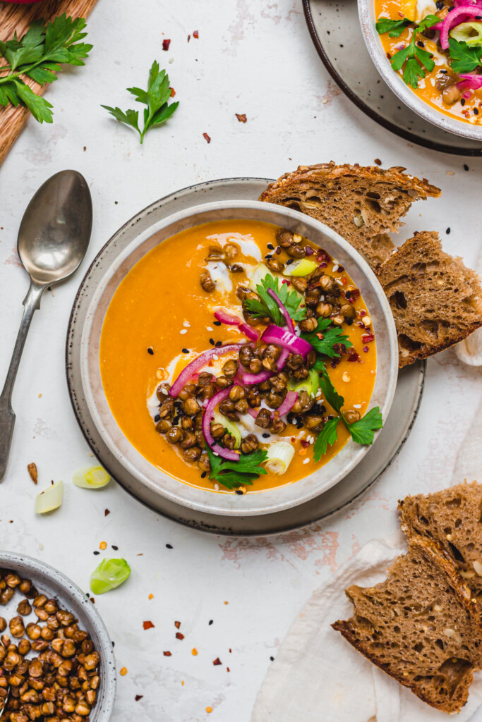 A bowl of Curried Lentil Soup topped with lentils