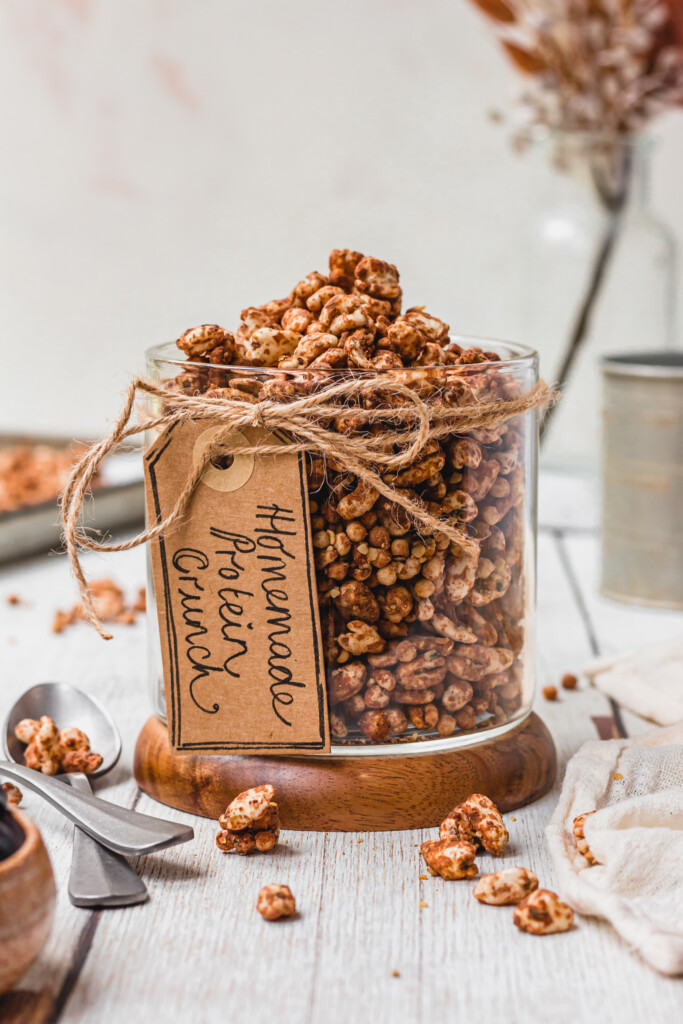 A glass jar full of Homemade Protein Crunch Cereal