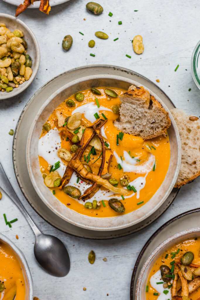 Close up of a bowl of Roasted Root Vegetable Soup topped with yoghurt