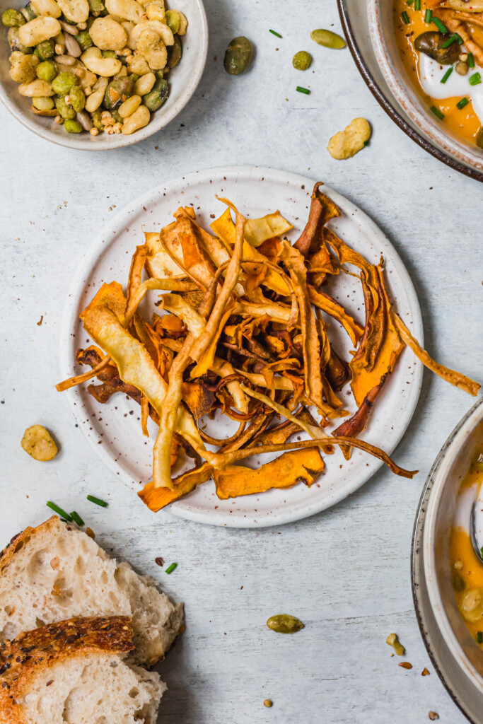 Parsnip and carrot peel crisps on a plate