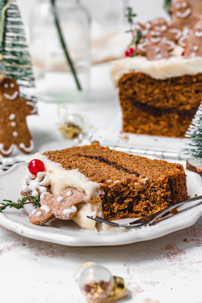 A fork and a slice of Vegan Gingerbread Loaf with Cream Cheese Frosting