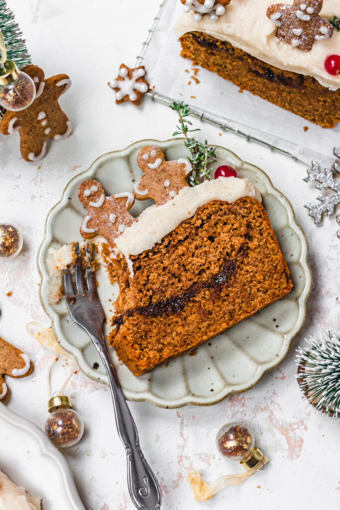 A slice of Vegan Gingerbread Loaf with Cream Cheese Frosting with the corner removed