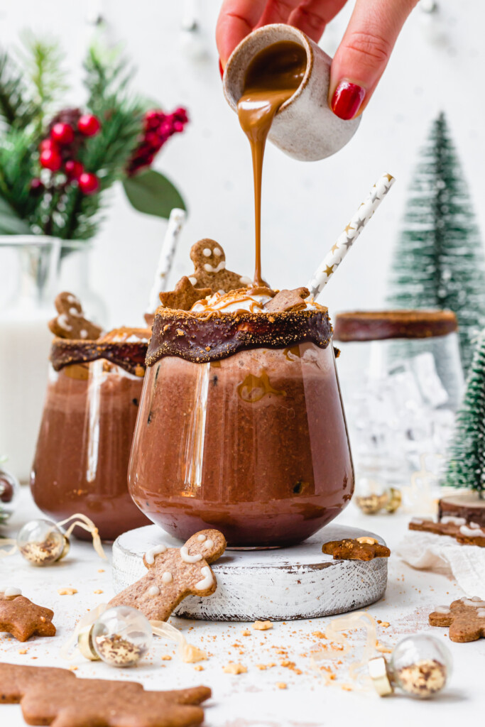 Pouring cookie butter over a Chocolate Gingerbread Mocktail