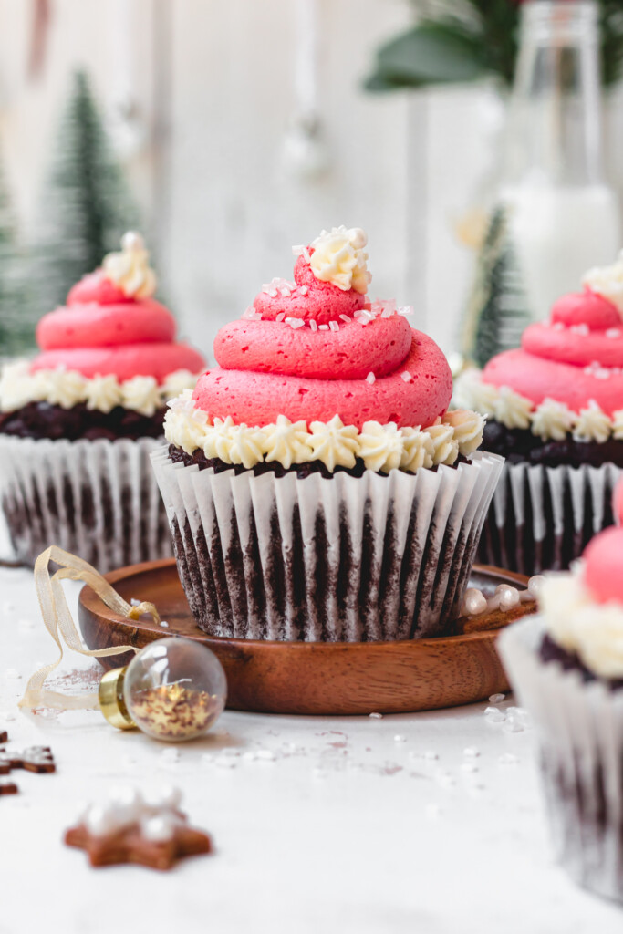 A Christmas Hat Chocolate Cupcake on a small wooden board