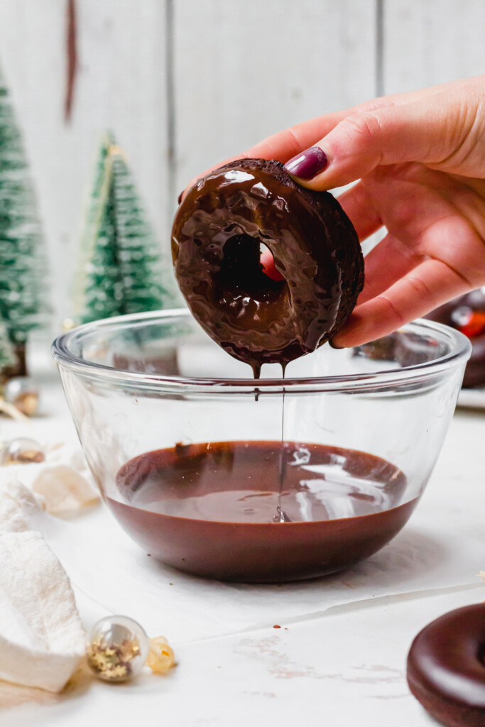 Dipping a doughnut into chocolate