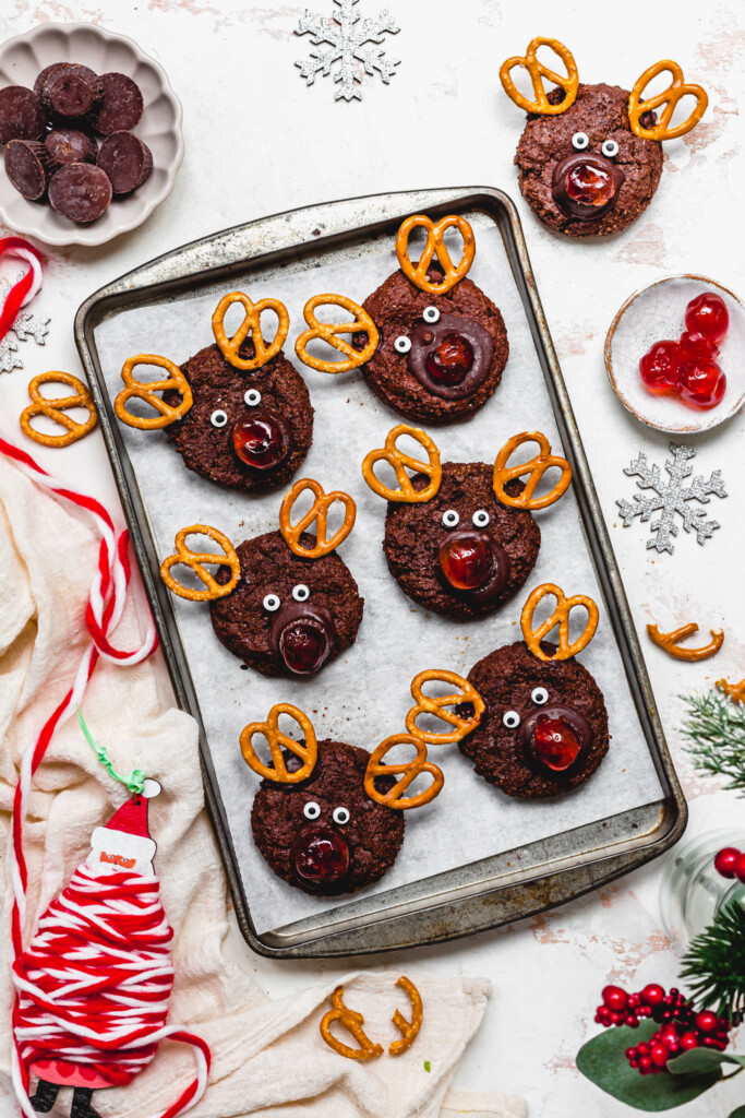 Six Vegan Chocolate Reindeer Cookies on a baking tray