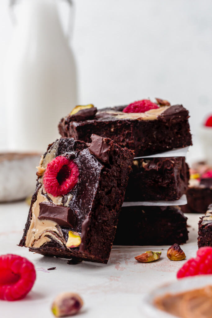 Three Chocolate Fudge Quinoa Brownies with one leaning up against them