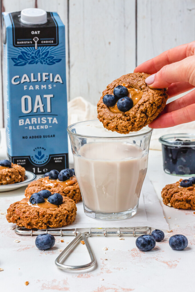 About to dip a cookie into a glass of Califia Farms Oat Barista Blend