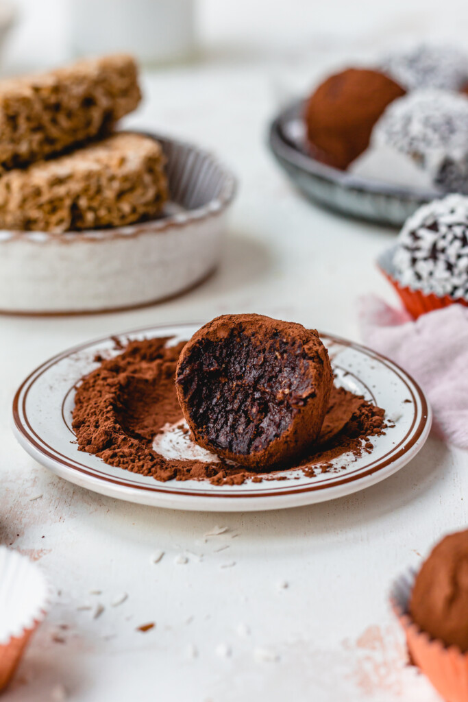 A cocoa dusted Chocolate Weetabix Protein Ball on a small plate