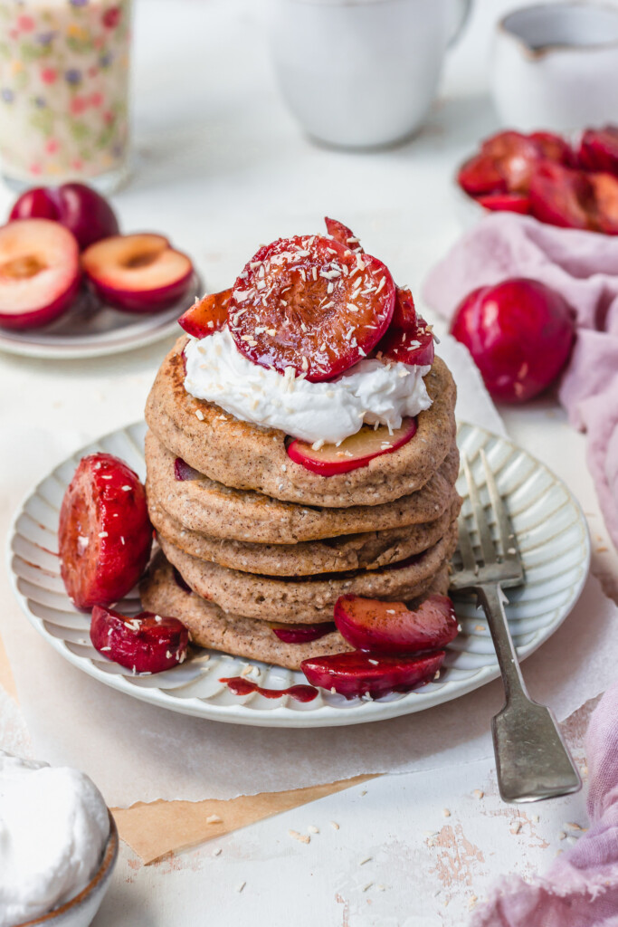 The top of a stack of Sticky Maple Plum Pancakes