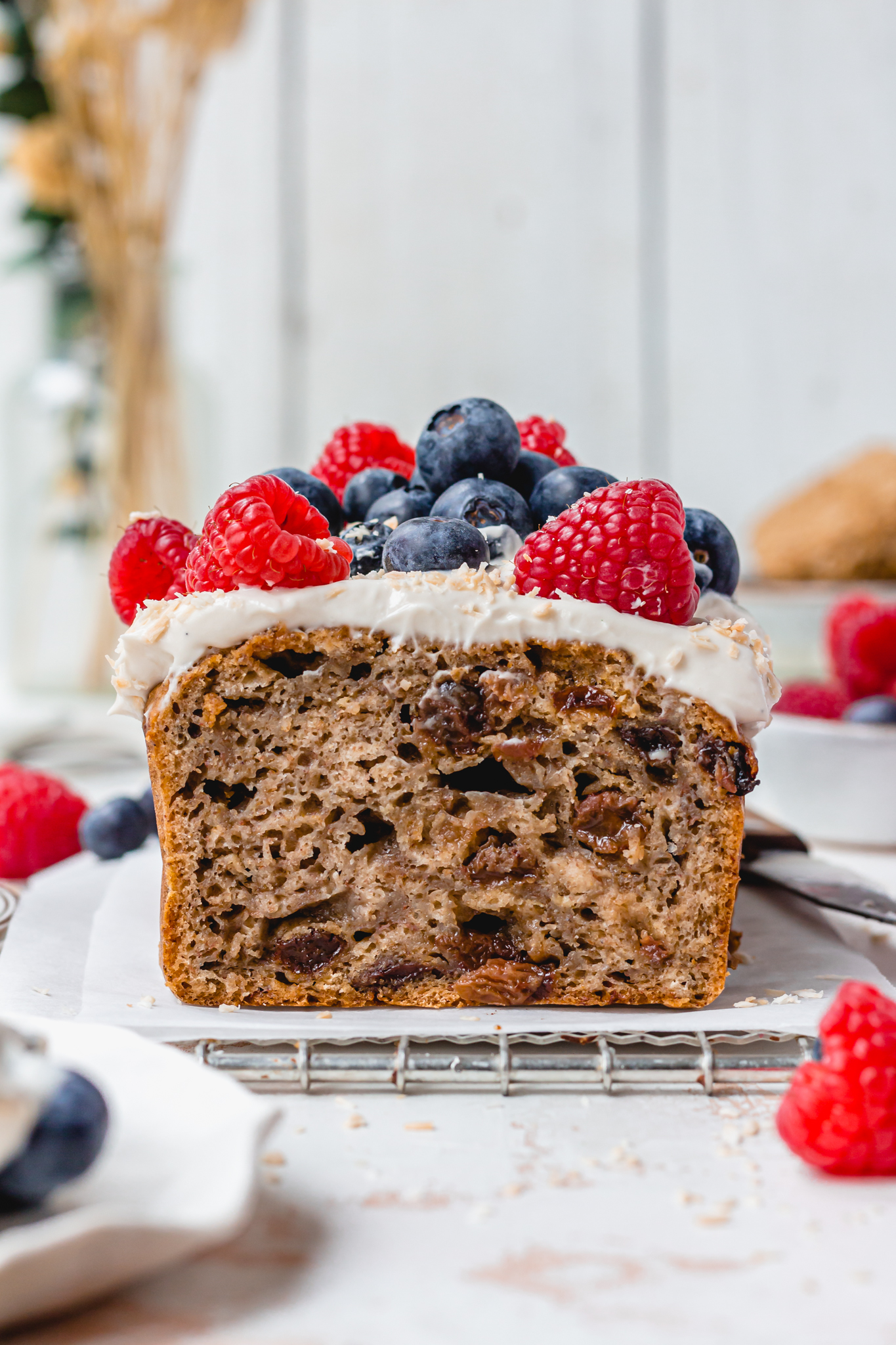 A loaf of Vegan Weetabix Cake with berries on top