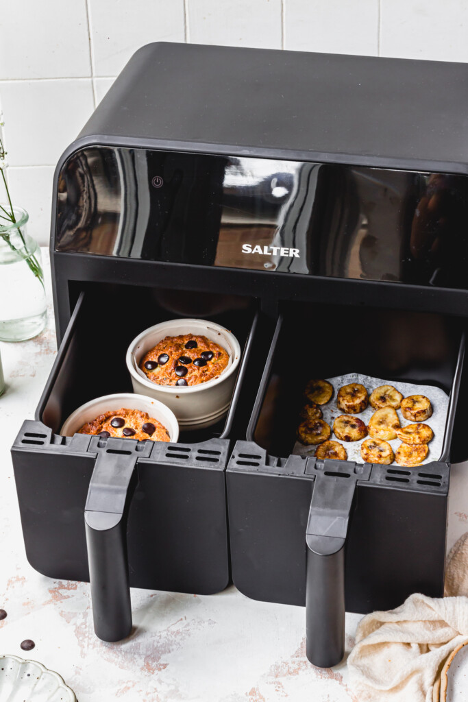 A Salter Air Fryer with two draws open with cookie skillets and banana
