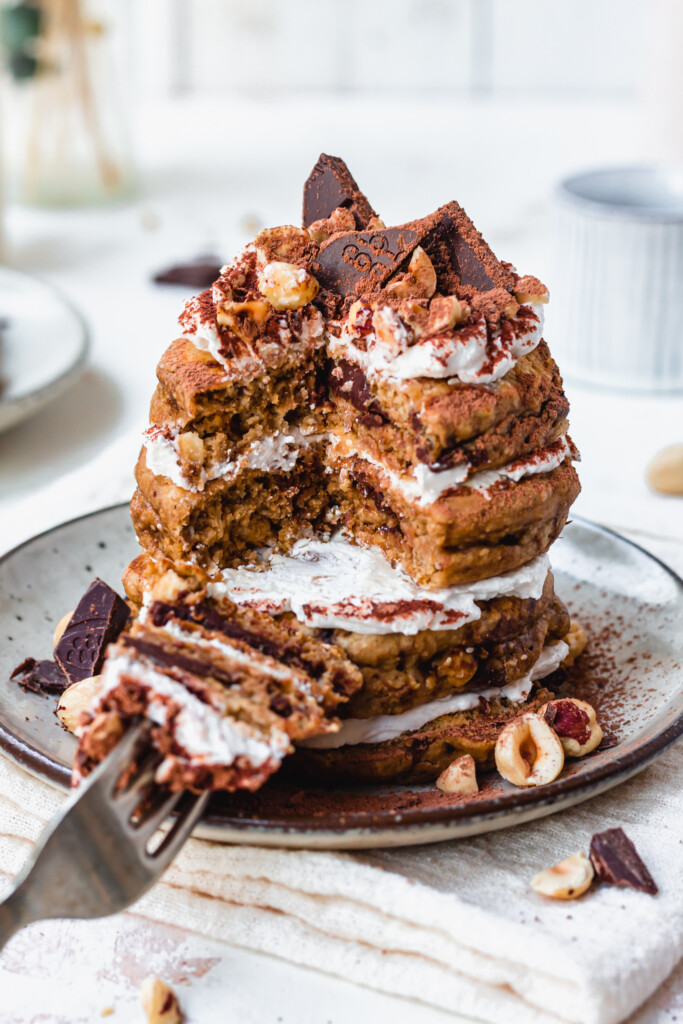 Close up of a stack of Chocolate Hazelnut Tiramisu Pancakes with a fork
