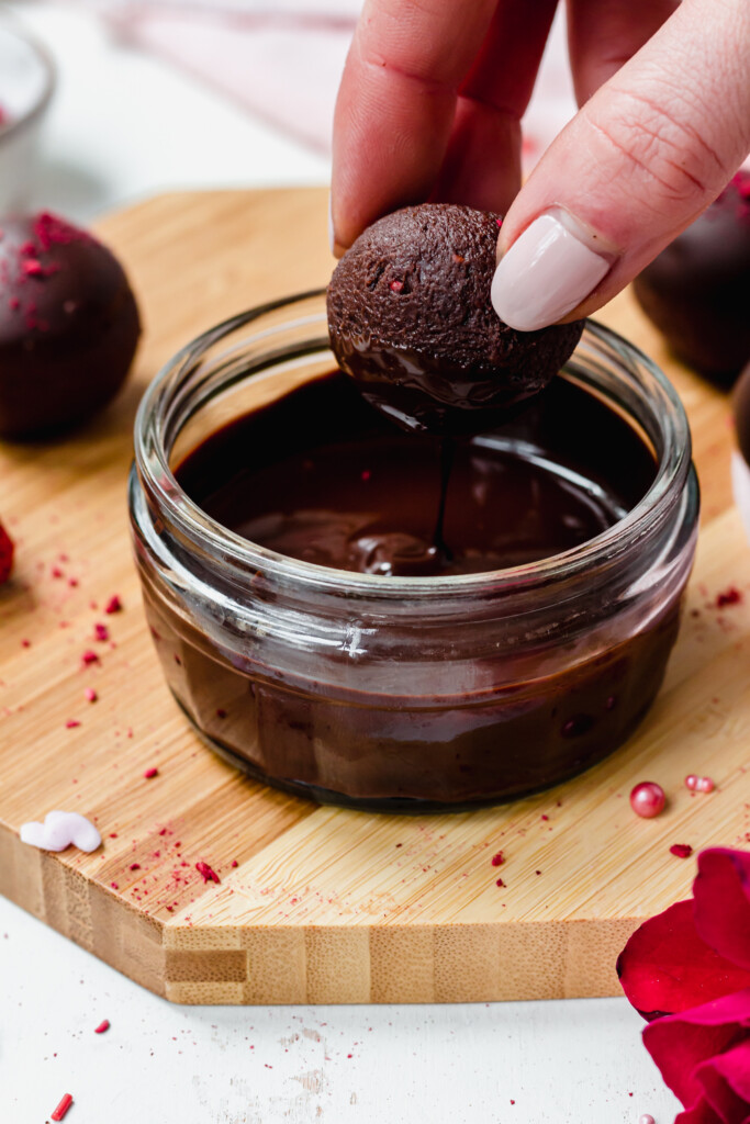 Dipping a Chocolate Strawberry Truffle into a pot of melted chocolate